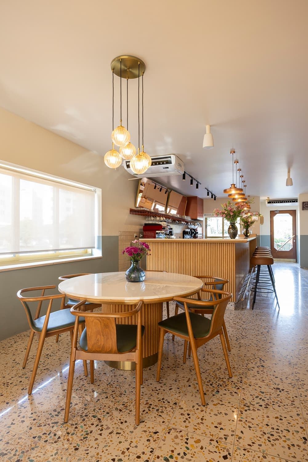 A calm portrait corner inside Bahi Café with a chair and plant